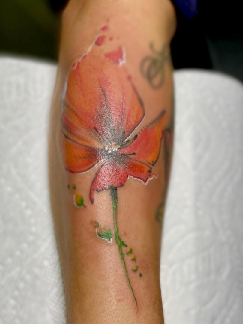 A close up of the arm tattoo of a flower