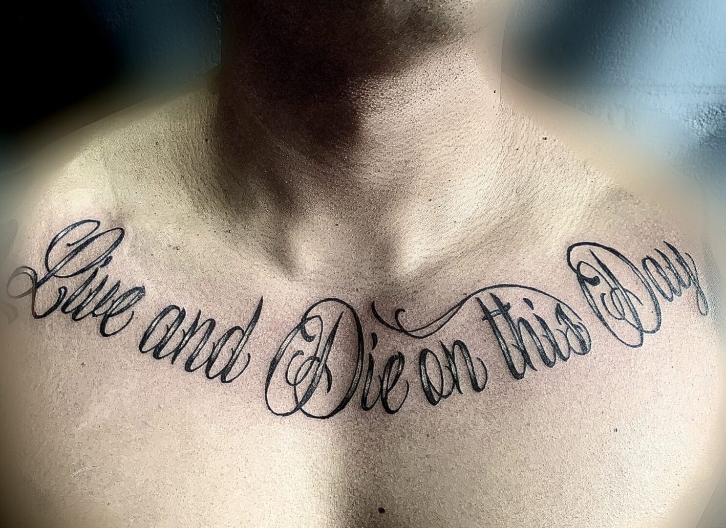 A man with a tattoo on his chest.
