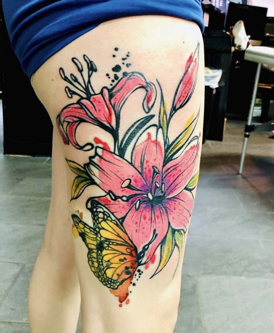A woman with a tattoo of flowers and a butterfly.