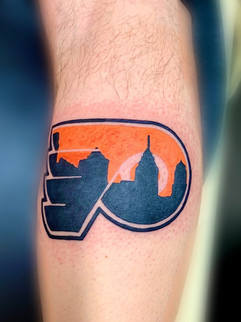 A tattoo of the city skyline is shown.