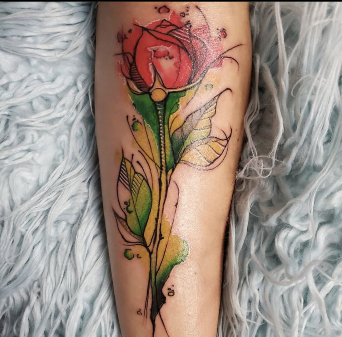A tattoo of a rose on the arm.