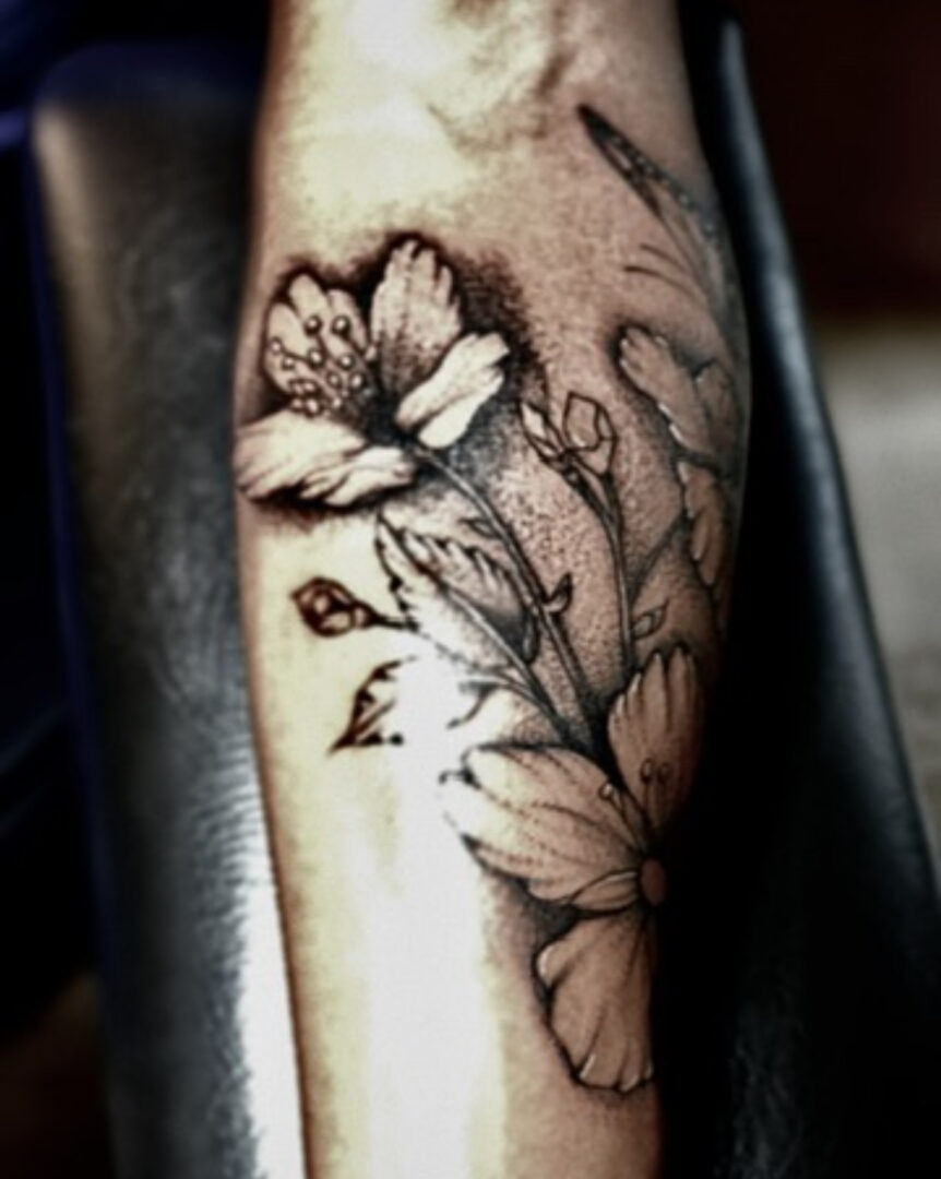 A tattoo of flowers on the arm