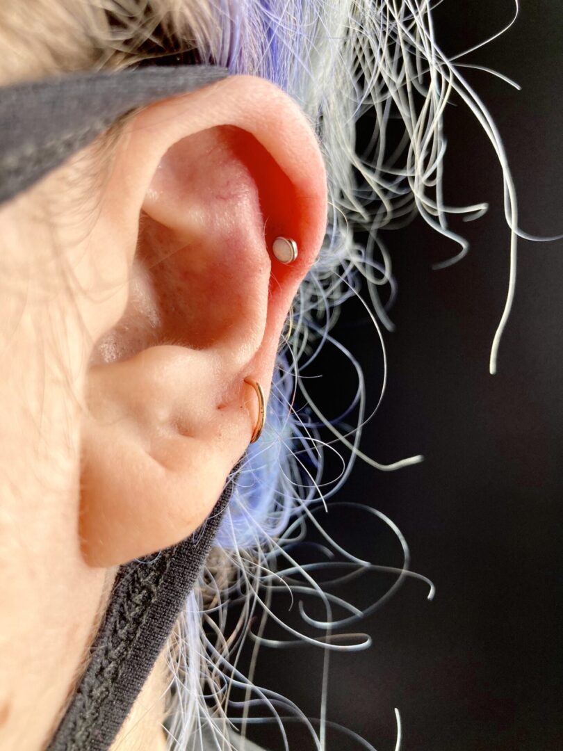 A person 's ear with some hair in it