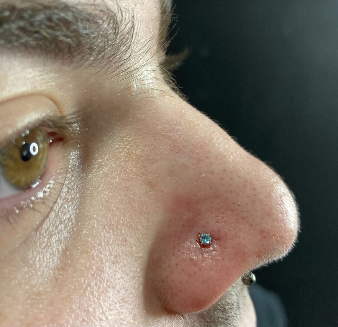 A man with a piercing in his nose.