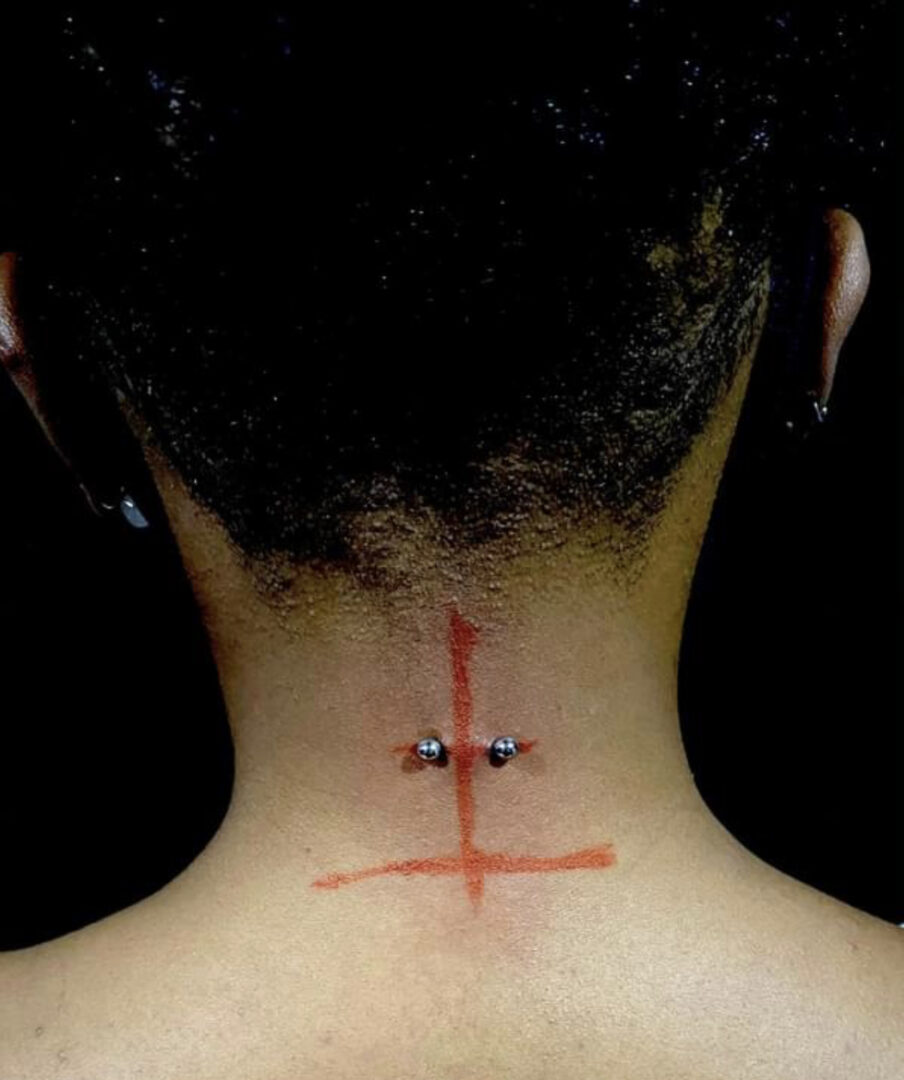 A person with their back turned and the neck marked with red ink.