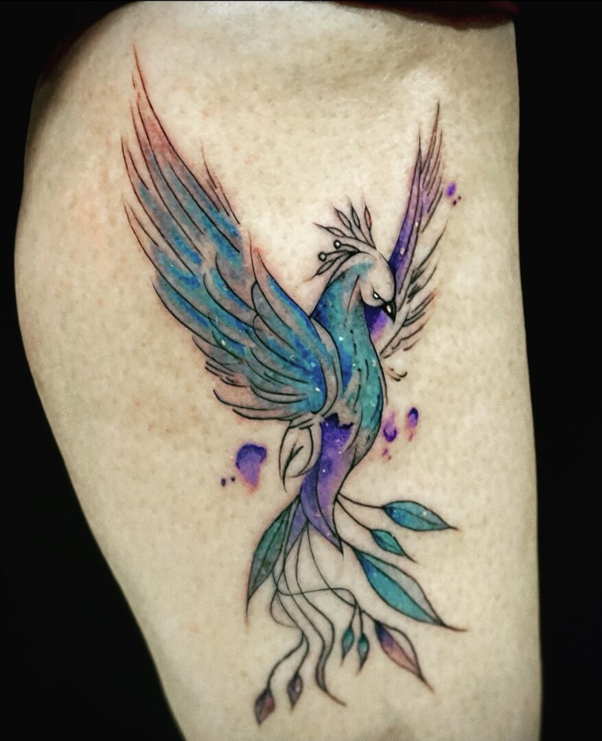 A tattoo of a bird with purple and blue feathers.
