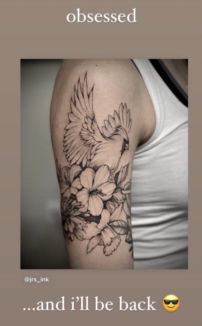A woman with a tattoo of a bird and flowers.