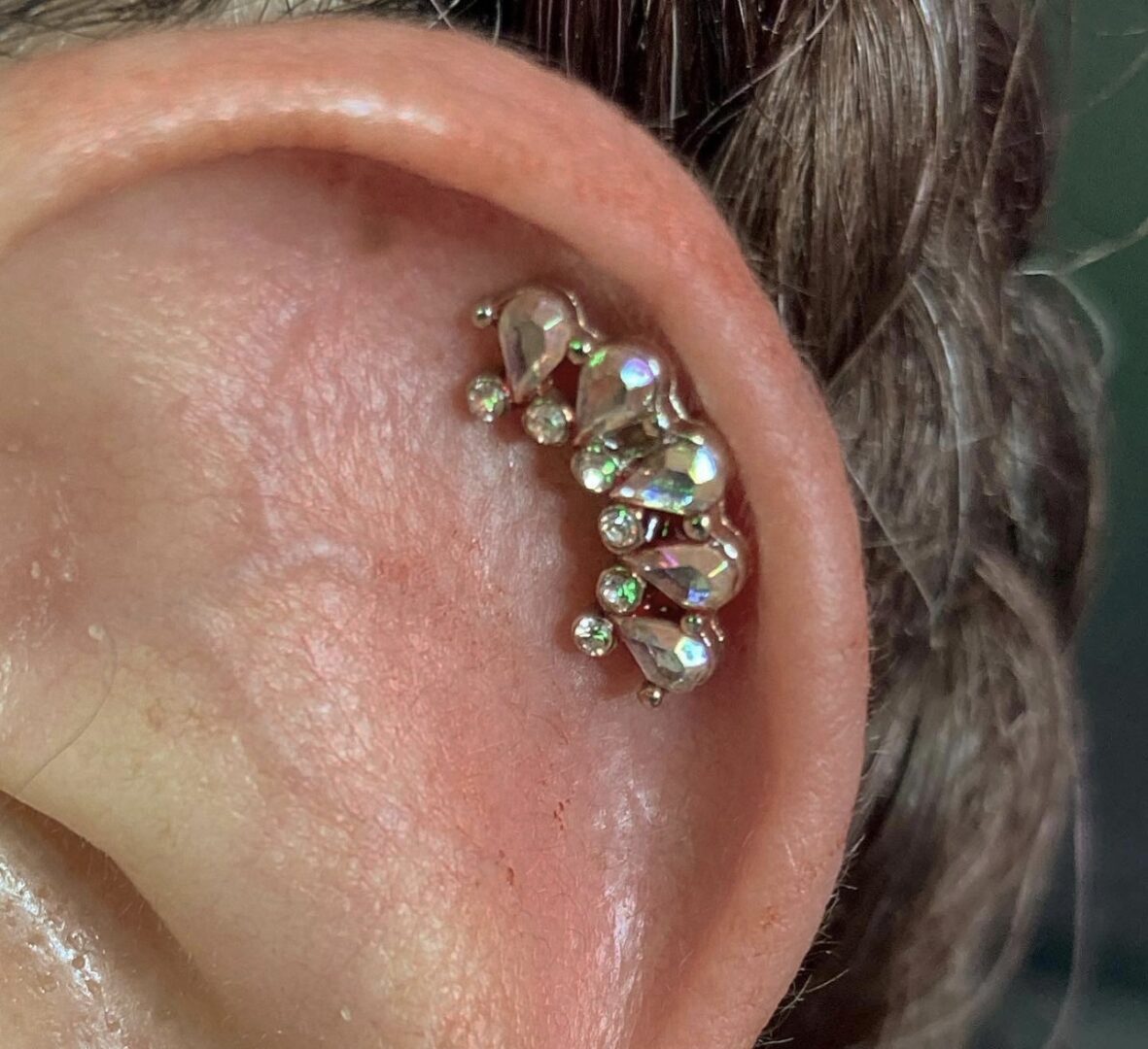 A close up of an ear with some kind of piercing