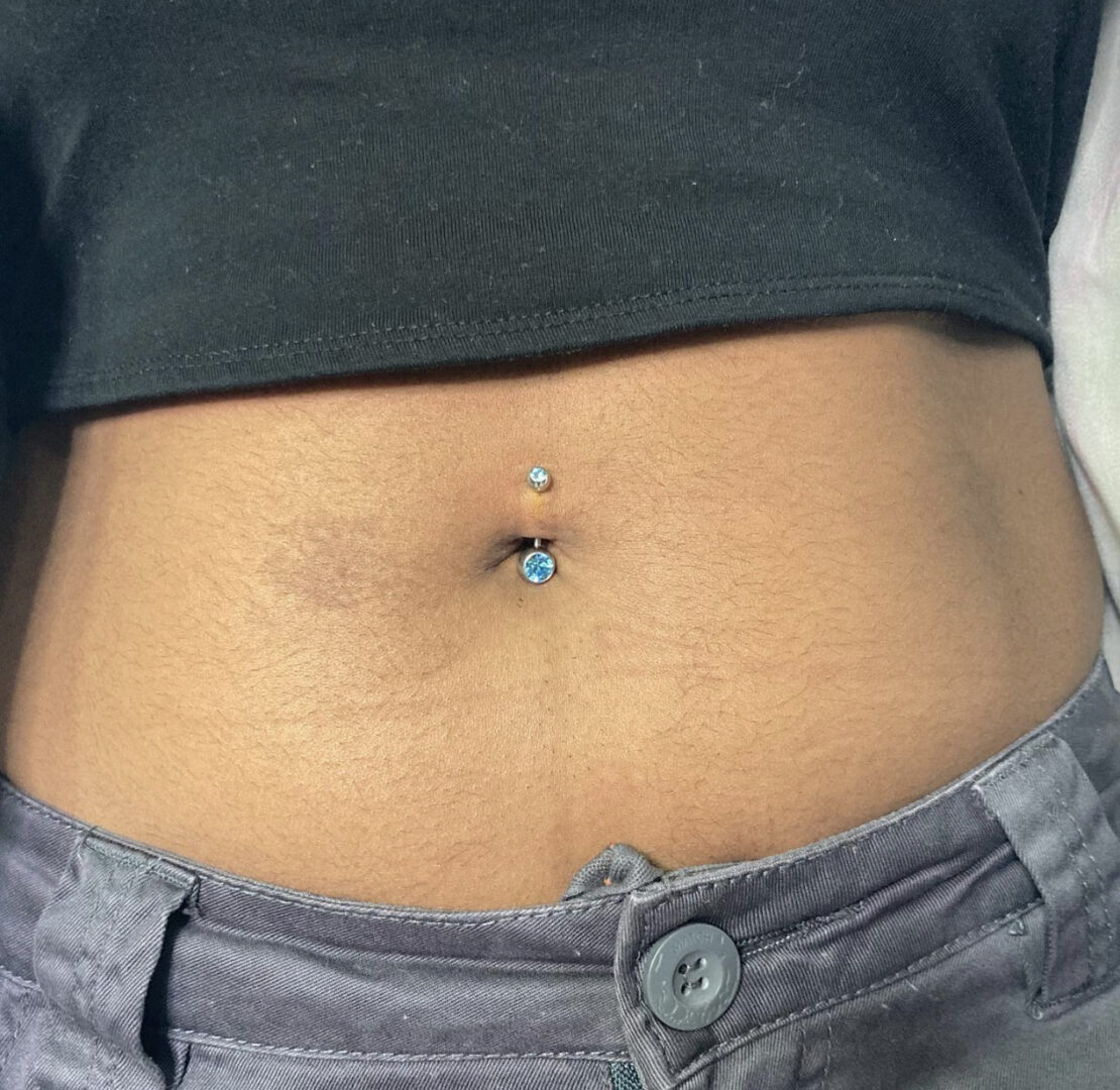 A woman with an upside down belly button piercing.