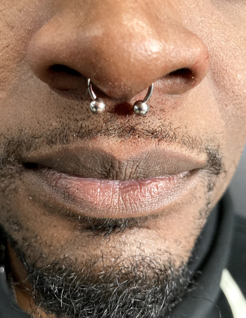 A man with a piercing on his nose.