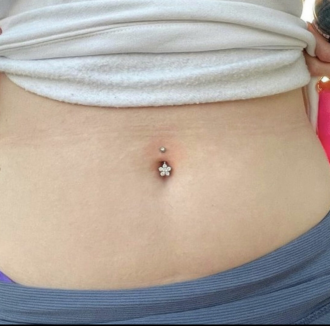 A woman with a star shaped belly button ring.