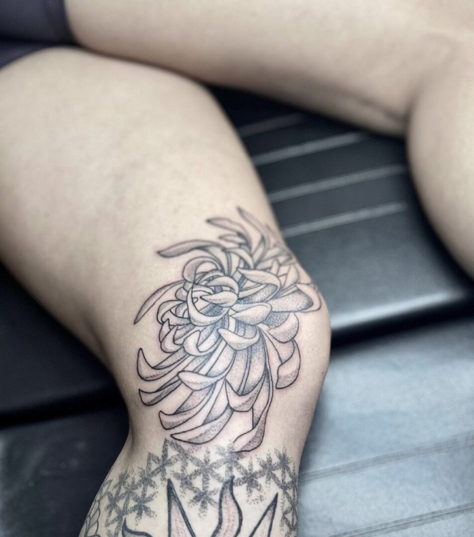 A person with tattoos on their legs.