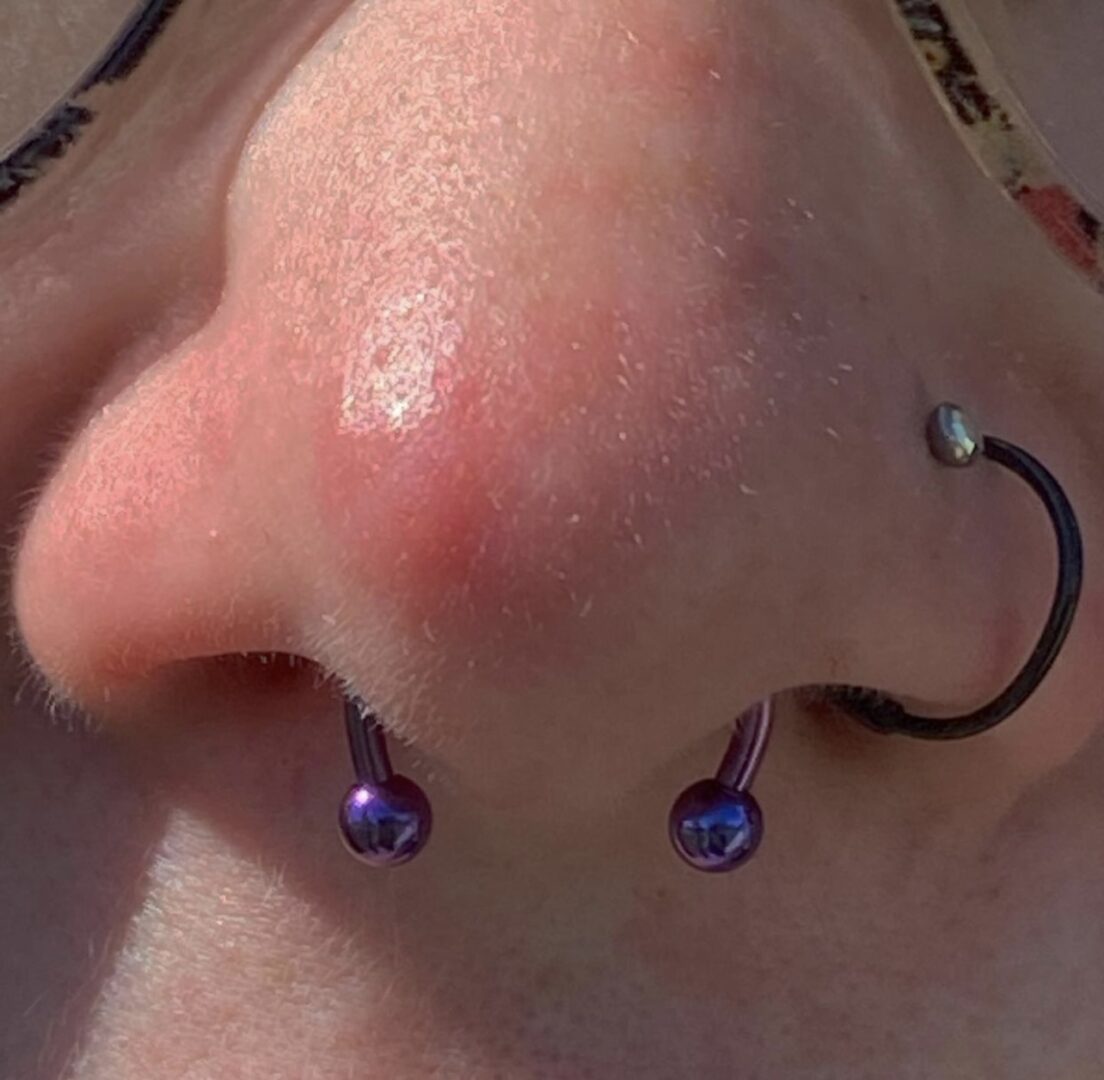 A person with their nose piercing and earring.