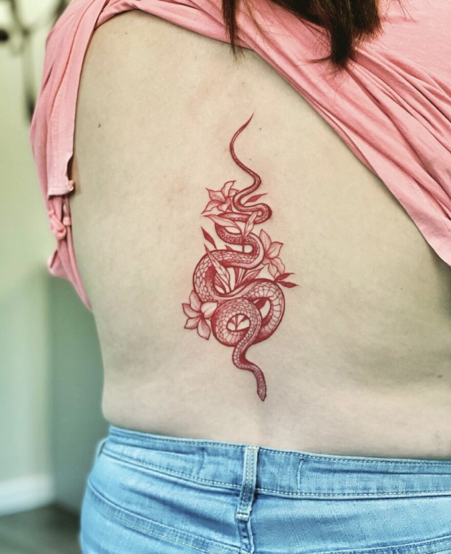 A woman with a tattoo of an animal on her stomach.