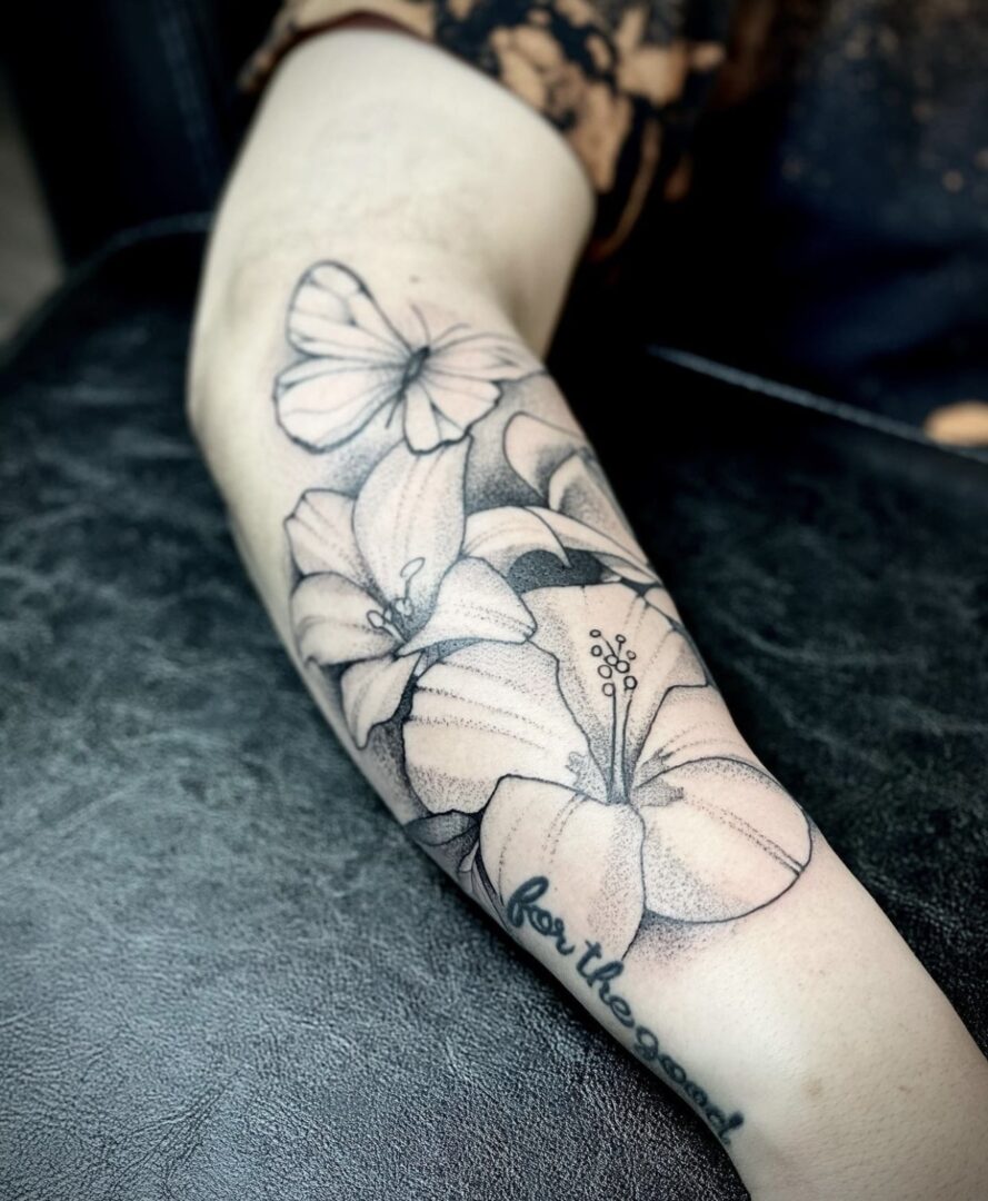 A woman with a tattoo of flowers on her arm.