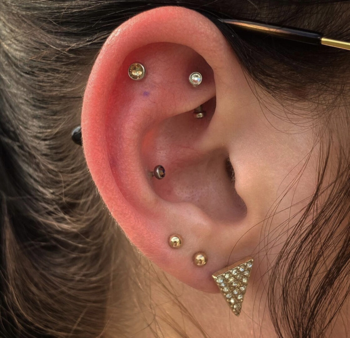 A woman with multiple piercings in her ear.
