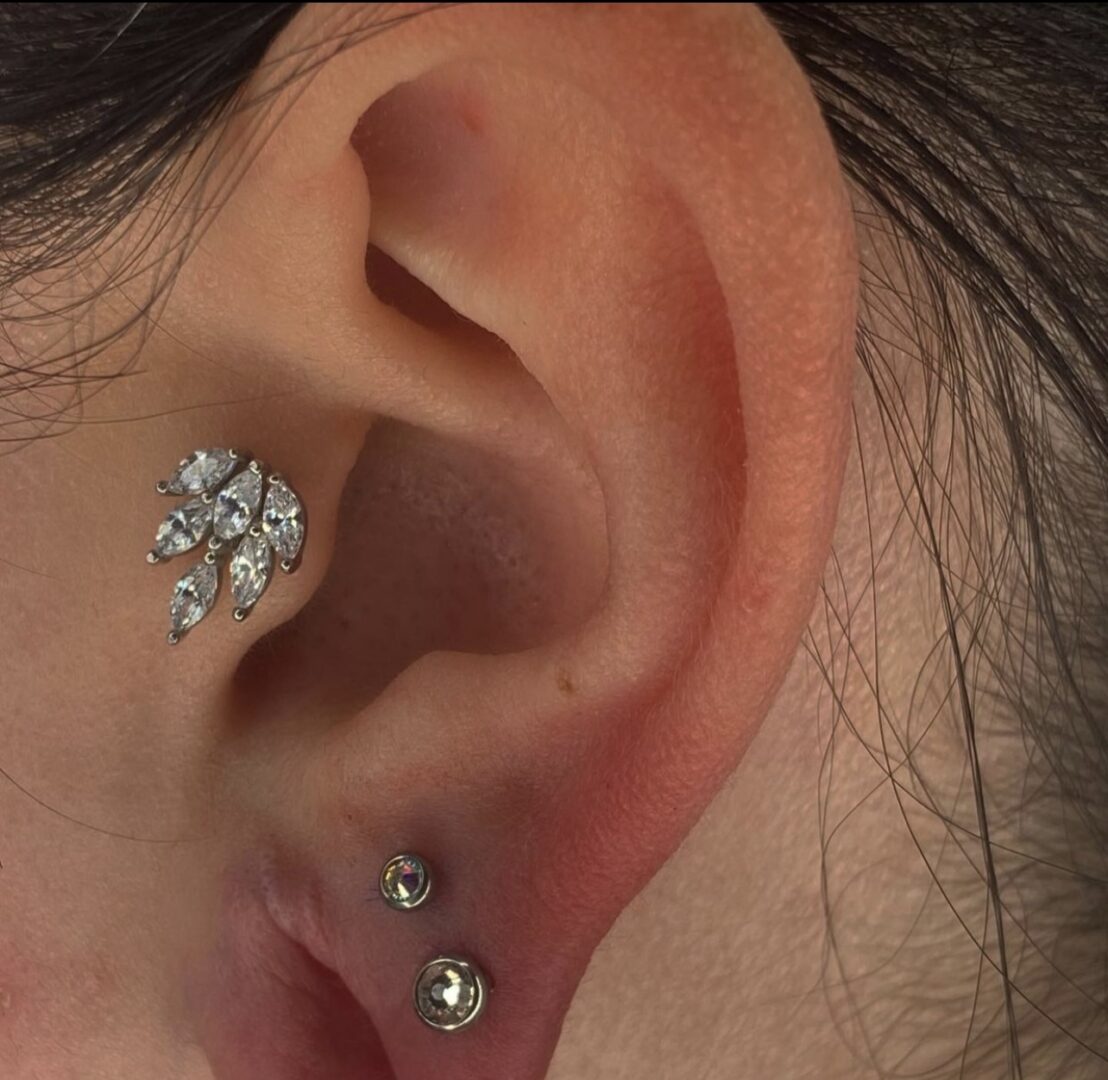 A woman with her ear pierced to look like she is wearing a ring.