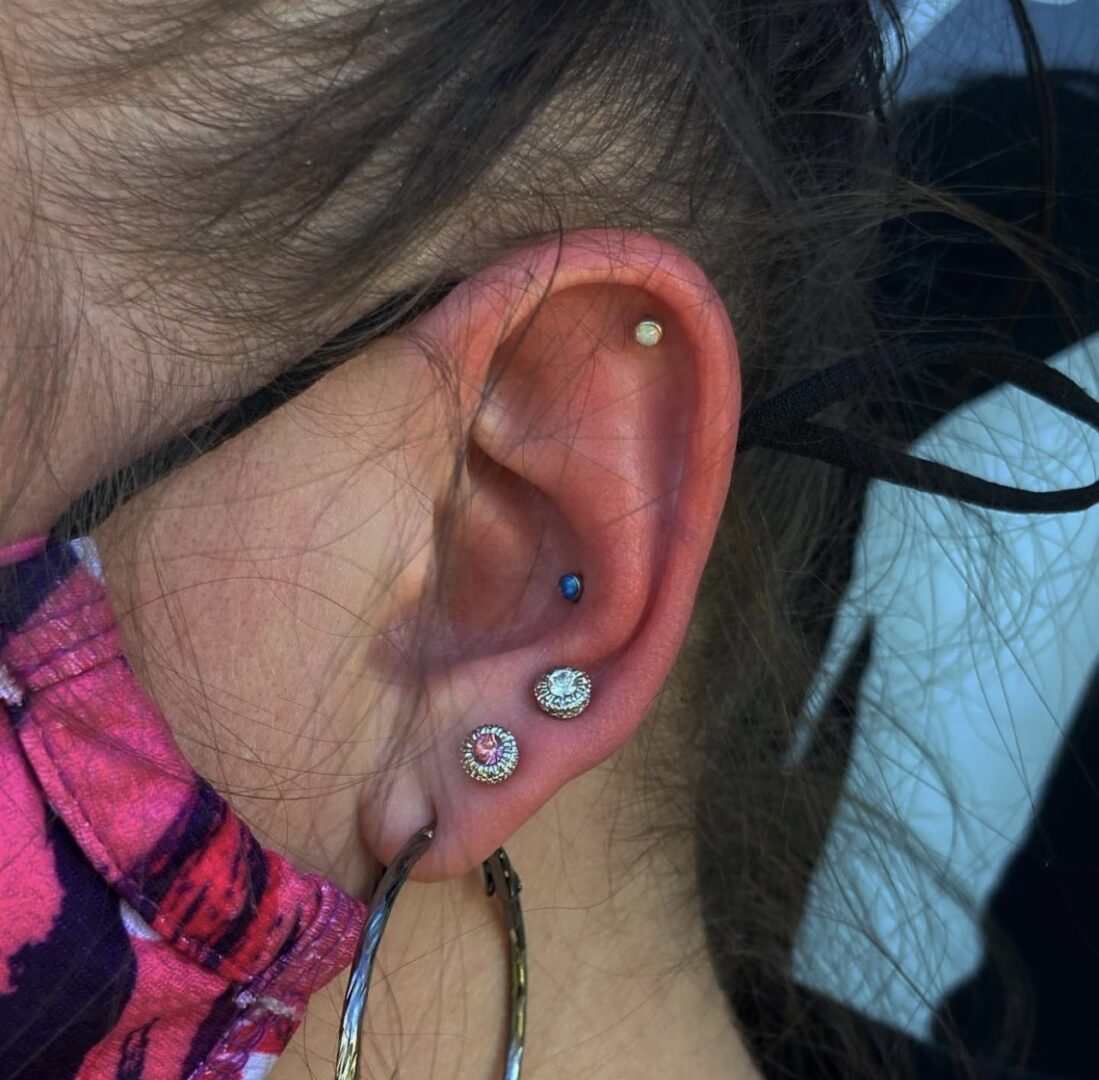 A woman with multiple piercings in her ear.