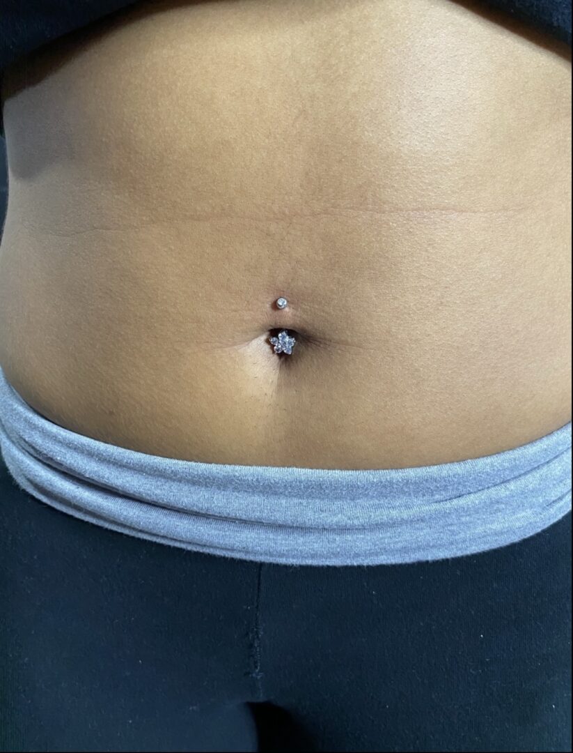 A woman with a belly button piercing.