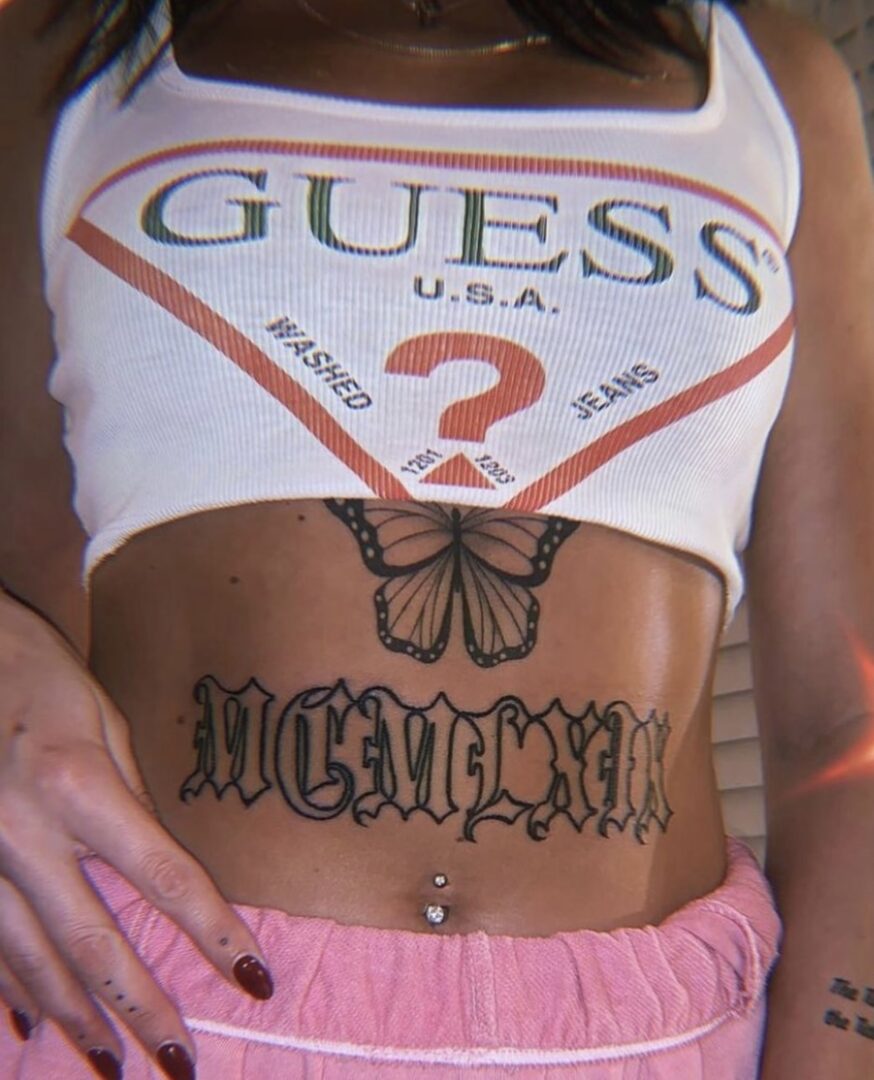 A woman with tattoos on her stomach and belly.