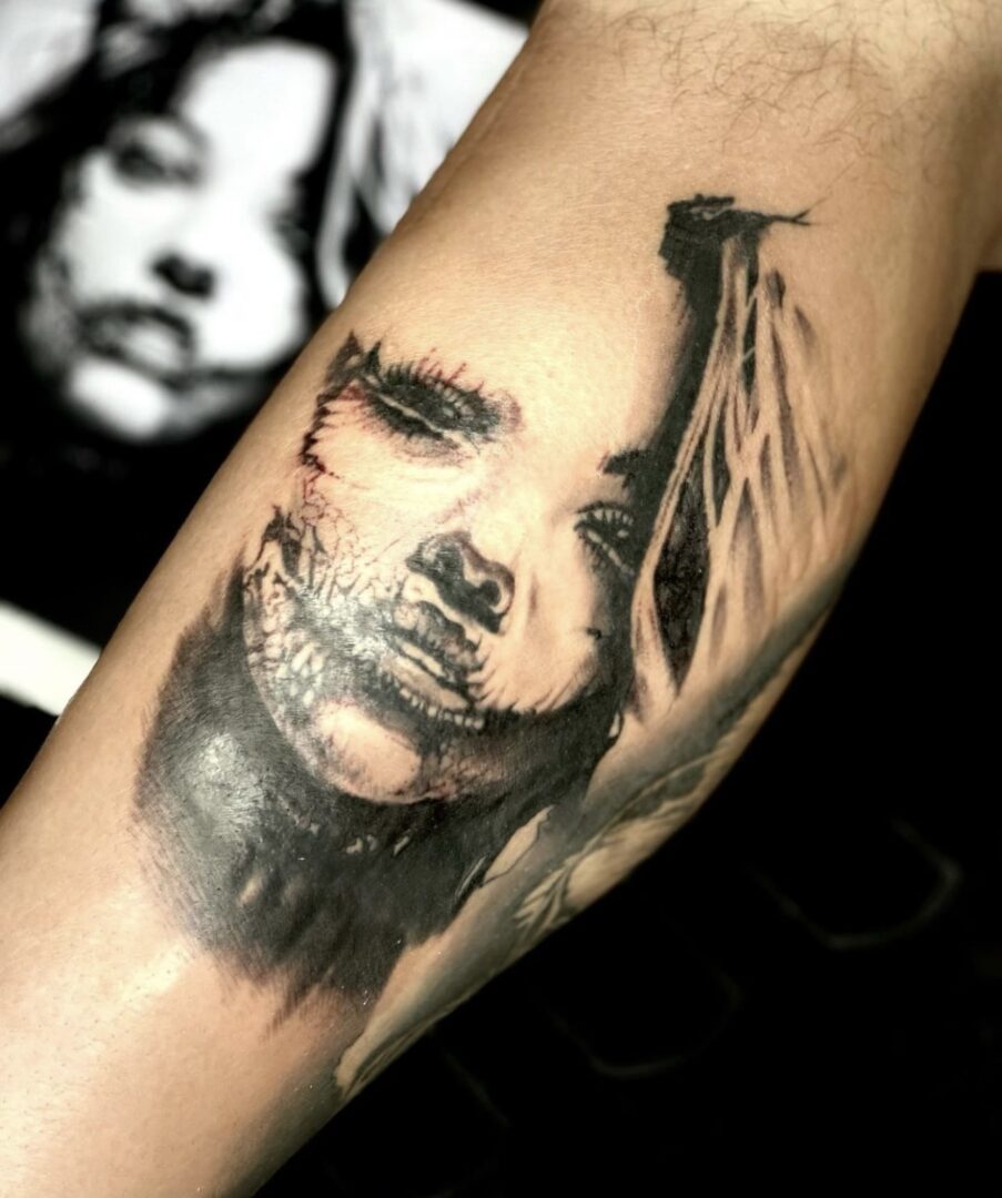 A woman 's face is painted on the arm of someone.