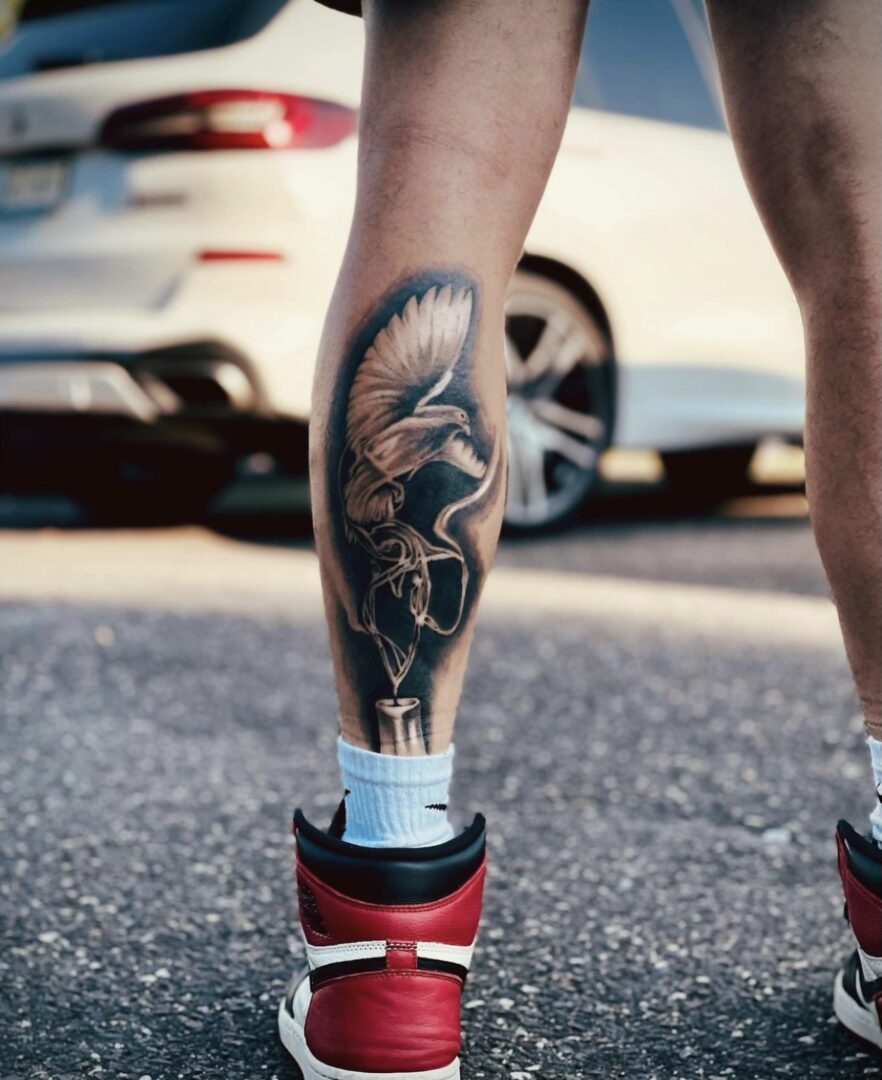 A person with tattoos on their legs