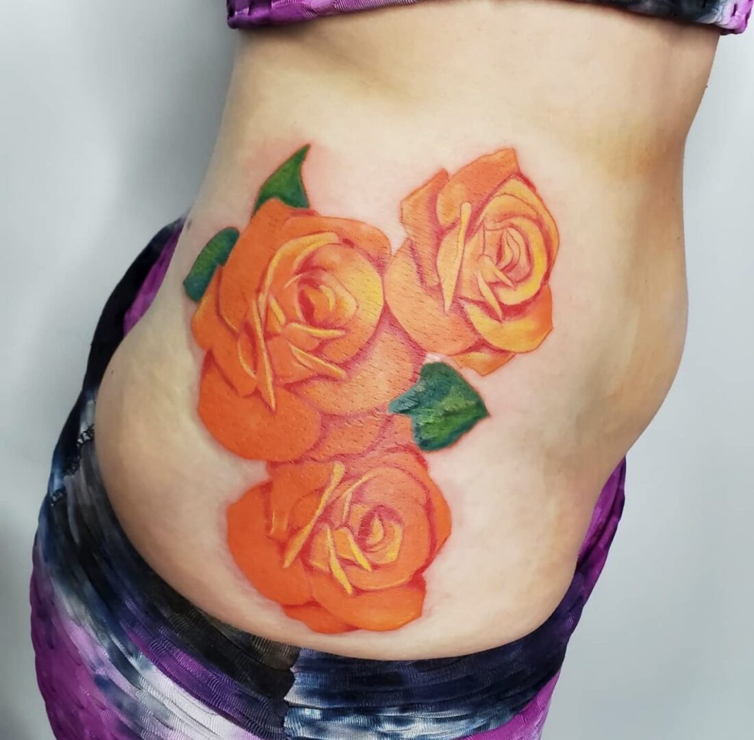 A woman with a tattoo of three roses.