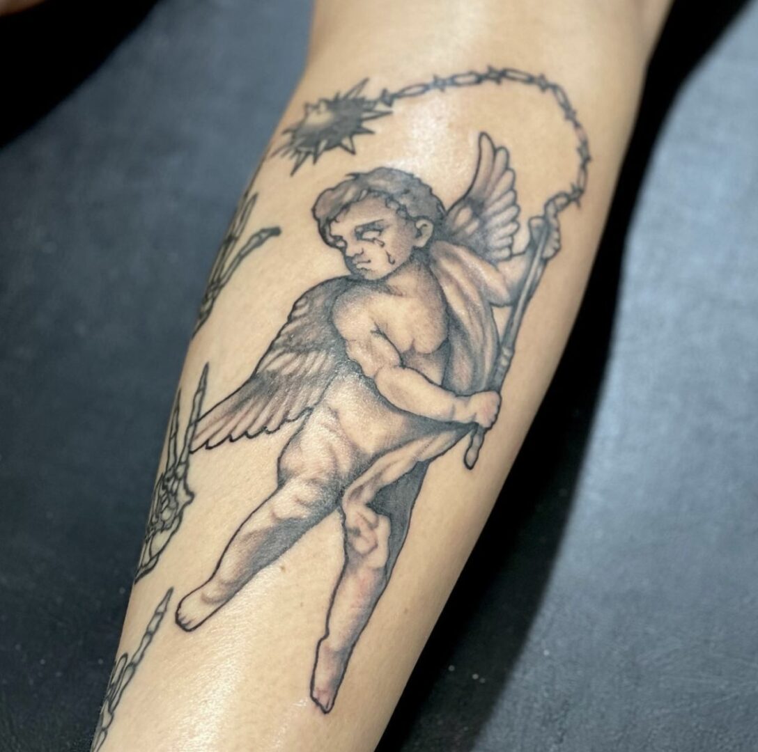 A tattoo of an angel with a bow and arrow.