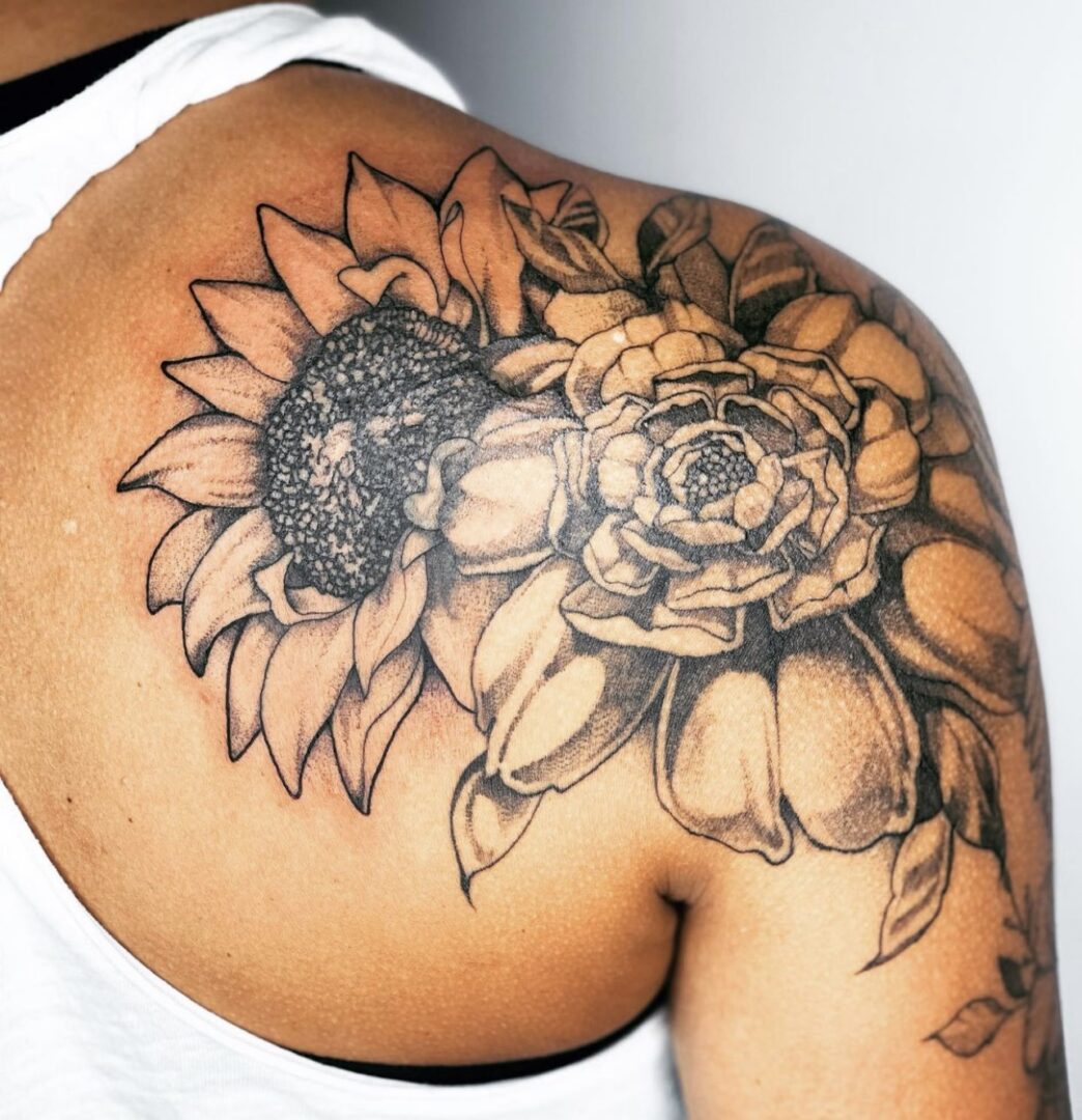 A man with a tattoo of flowers on his shoulder.