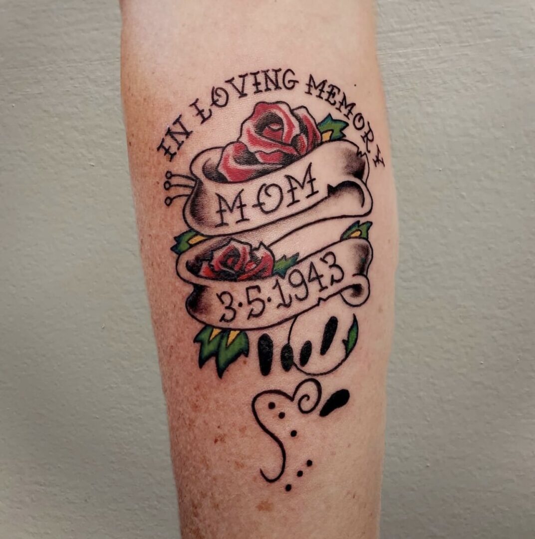 A tattoo of the name mom and date for memorial day.