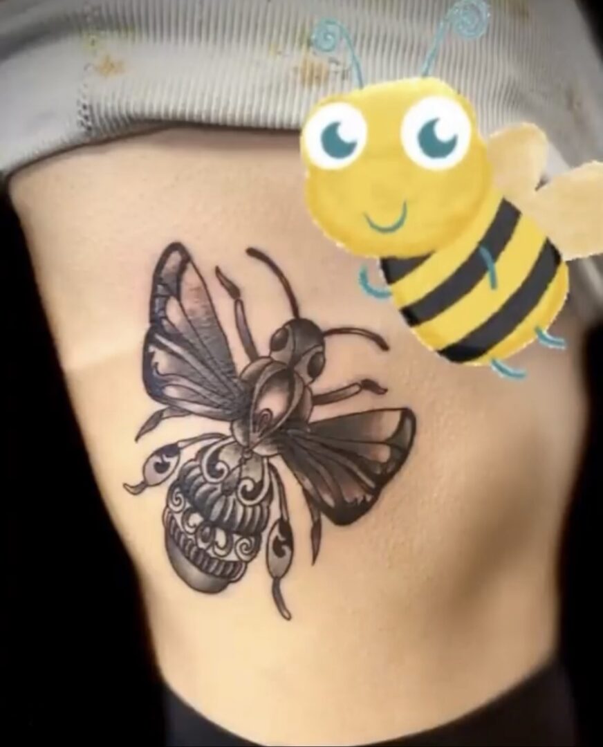 A bee and a butterfly tattoo on the side of a woman 's stomach.