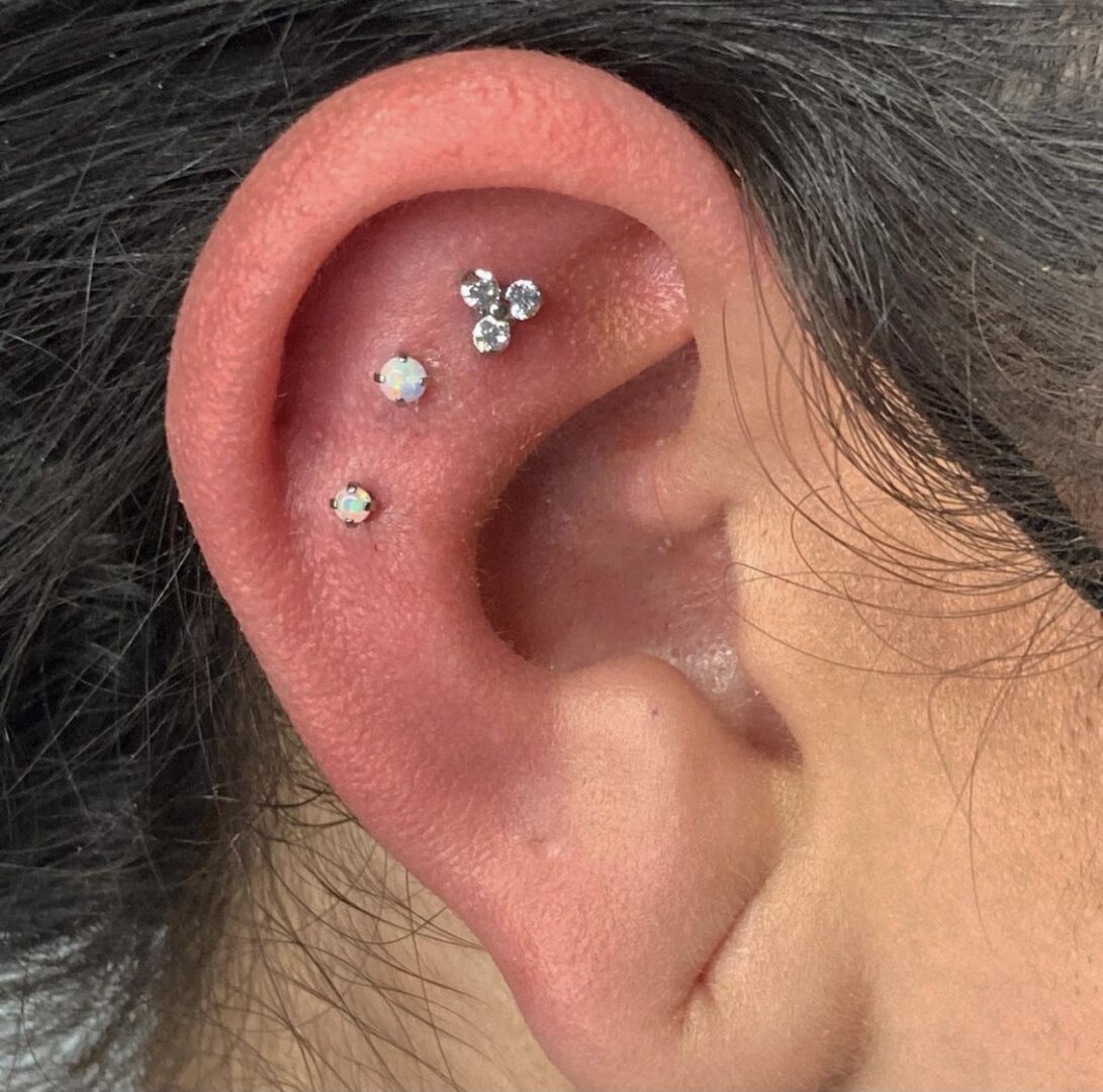 A man with multiple piercings in his ear.