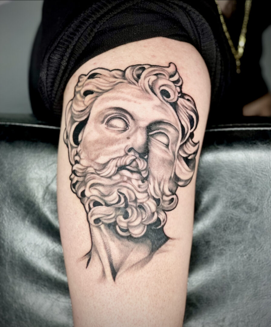 A tattoo of an old man with a beard