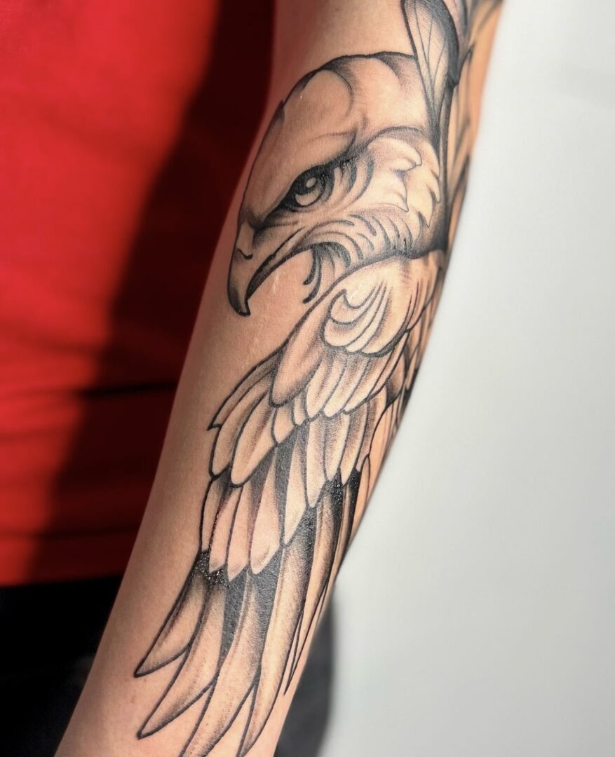 A tattoo of an eagle with its wings spread.