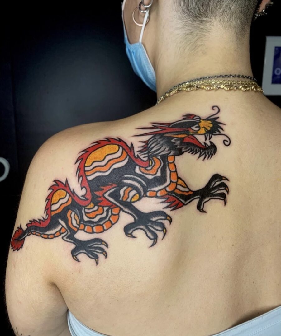 A man with a dragon tattoo on his back