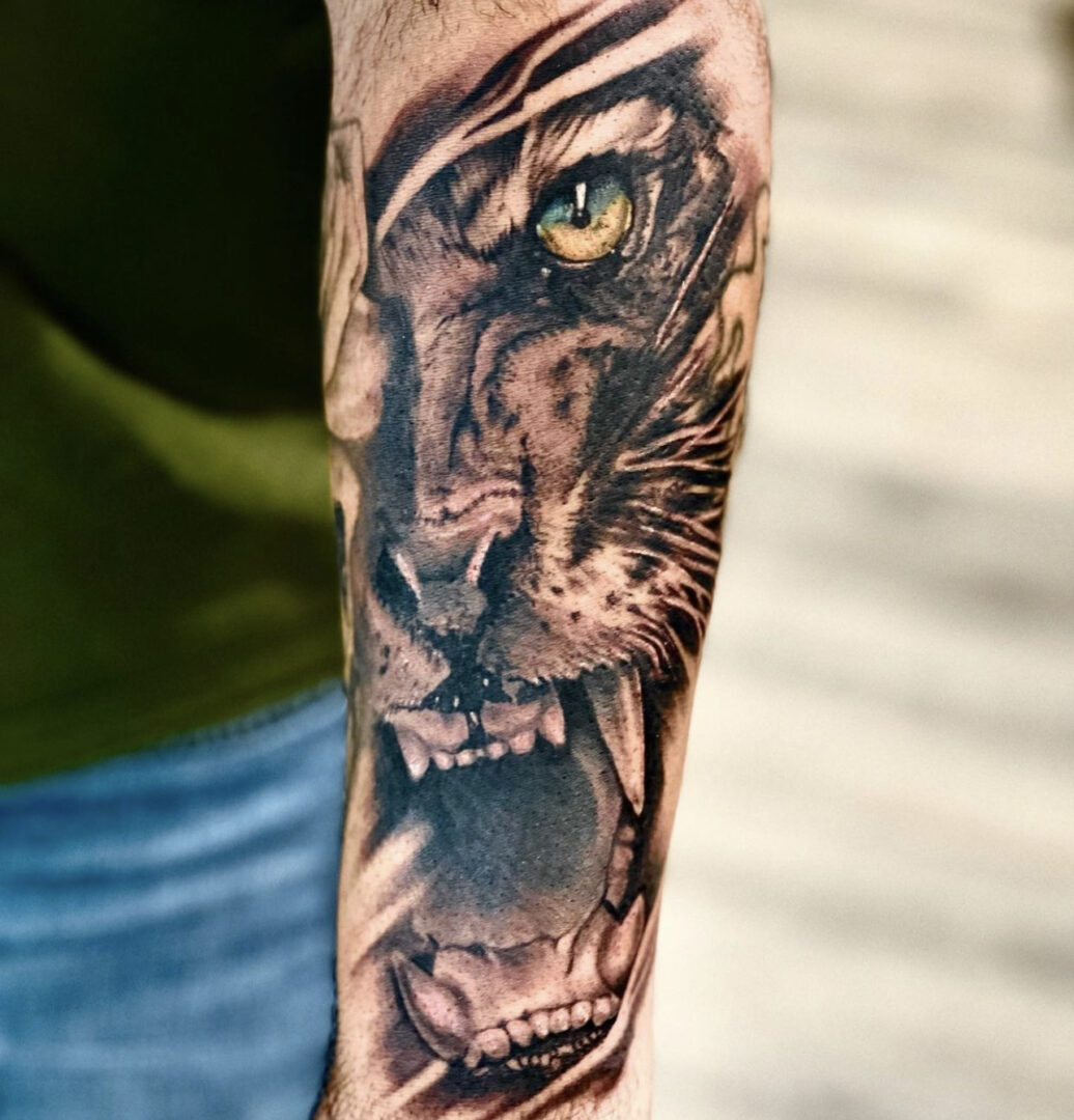 A man with a tiger tattoo on his arm.