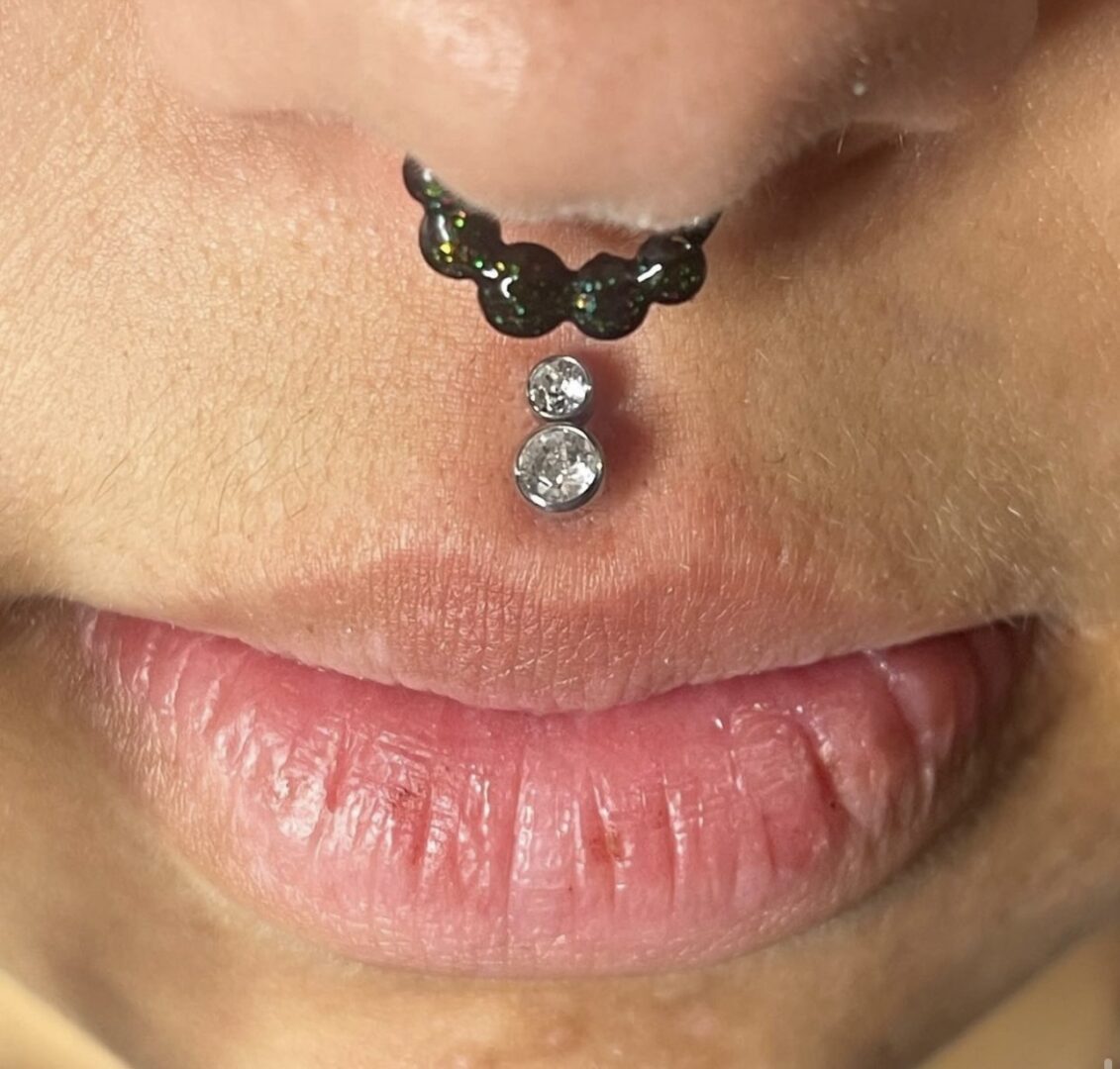 A woman with a piercing on her nose.