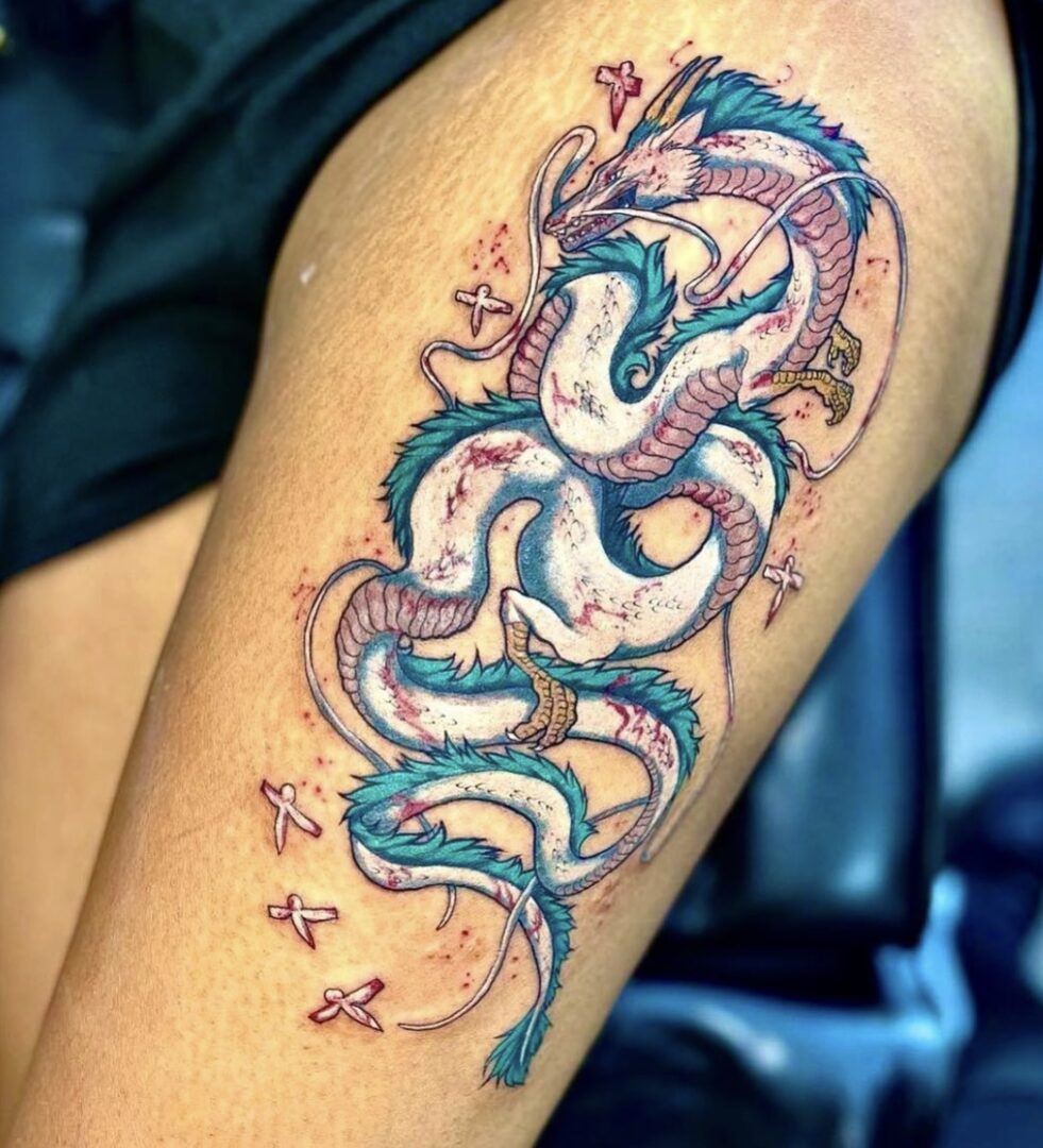 A woman with a tattoo of a dragon on her arm.