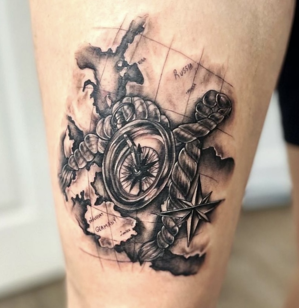 A tattoo of a compass and other items