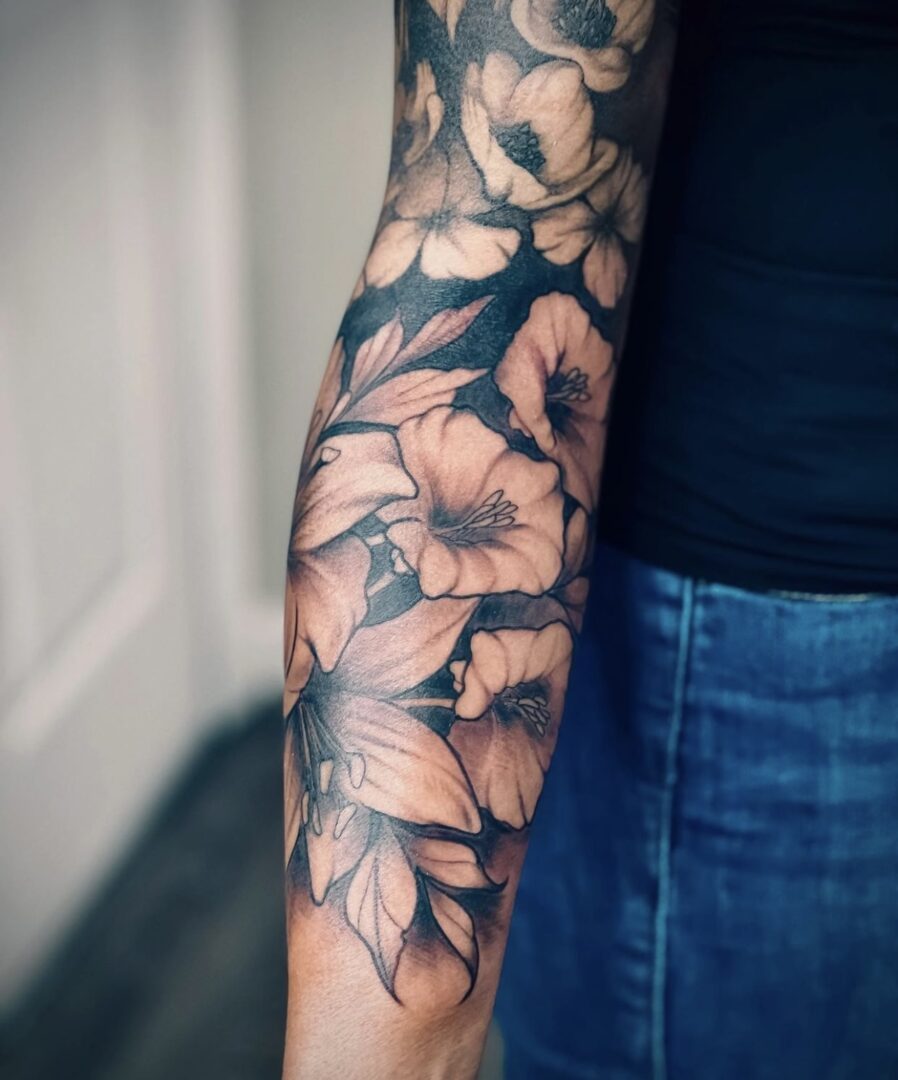 A woman with a tattoo of flowers on her arm.