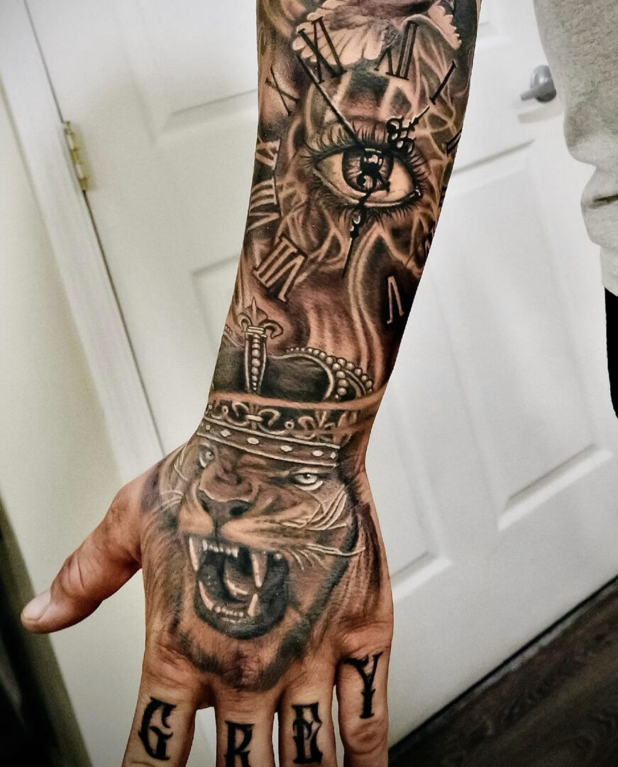 A man 's arm with tattoos of an animal and clock.