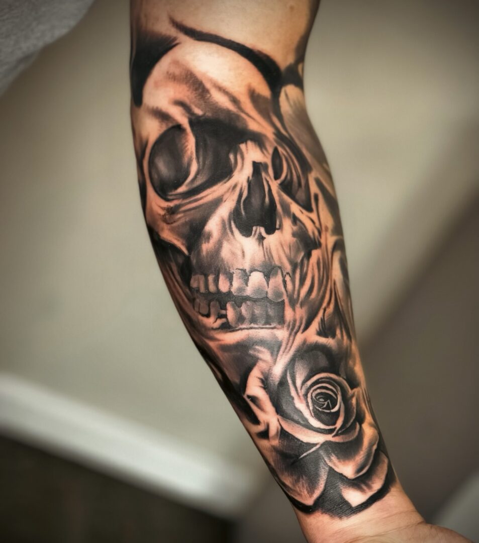 A man with a skull tattoo on his arm.