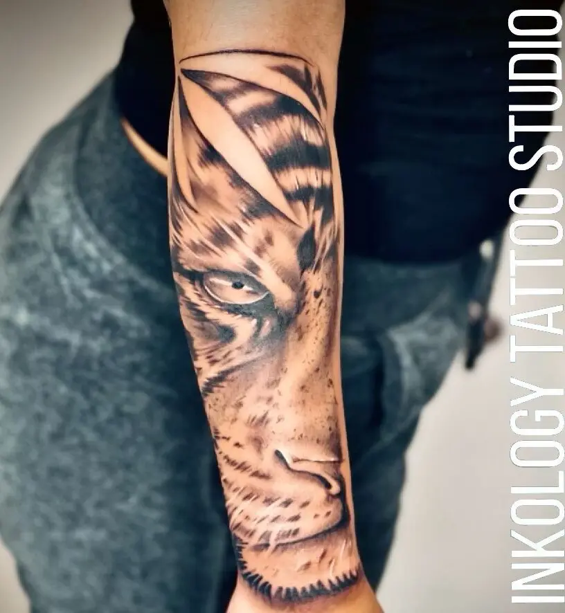A person with a tiger tattoo on their arm