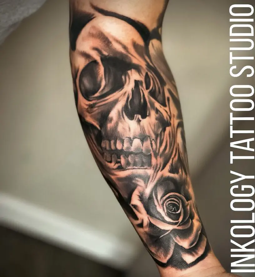A man with a skull and rose tattoo on his arm.