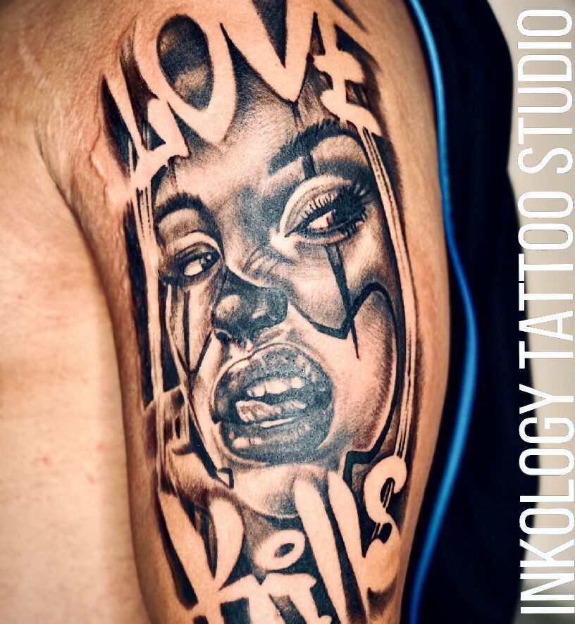 A tattoo of a woman 's face with words written in it.